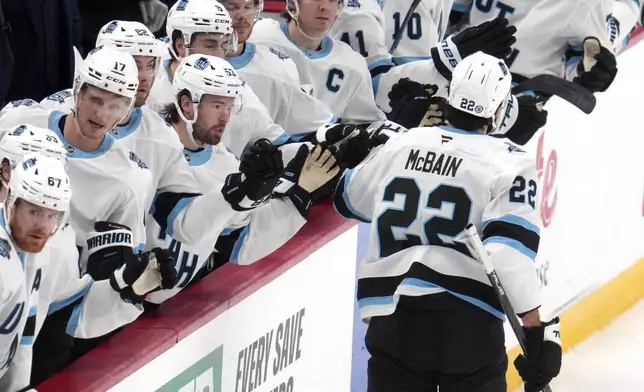 Utah Hockey Club's Jack McBain (22) returns to the bench after scoring during the first period of an NHL hockey game against the Pittsburgh Penguins, Saturday, Nov. 23, 2024, in Pittsburgh. (AP Photo/Gene J. Puskar)