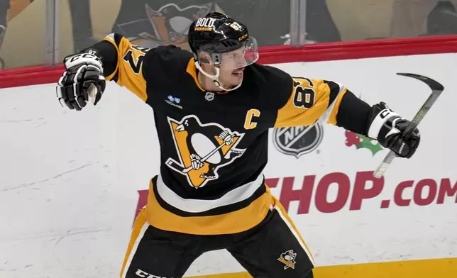 Pittsburgh Penguins' Sidney Crosby (87) celebrates after getting his 600th career goal in the NHL during the second period of an NHL hockey game against the Utah Hockey Club, Saturday, Nov. 23, 2024, in Pittsburgh. (AP Photo/Gene J. Puskar)