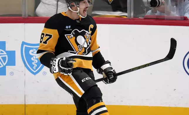 Pittsburgh Penguins' Sidney Crosby (87) celebrates after getting his 600th career goal in the NHL during the second period of an NHL hockey game against the Utah Hockey Club, Saturday, Nov. 23, 2024, in Pittsburgh. (AP Photo/Gene J. Puskar)