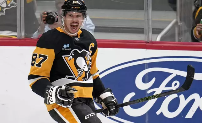 Pittsburgh Penguins' Sidney Crosby (87) celebrates after getting his 600th career goal in the NHL during the second period of an NHL hockey game against the Utah Hockey Club, Saturday, Nov. 23, 2024, in Pittsburgh. (AP Photo/Gene J. Puskar)