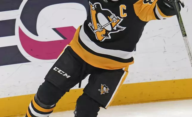 Pittsburgh Penguins' Sidney Crosby (87) celebrates after getting his 600th career goal in the NHL during the second period of an NHL hockey game against the Utah Hockey Club, Saturday, Nov. 23, 2024, in Pittsburgh. (AP Photo/Gene J. Puskar)