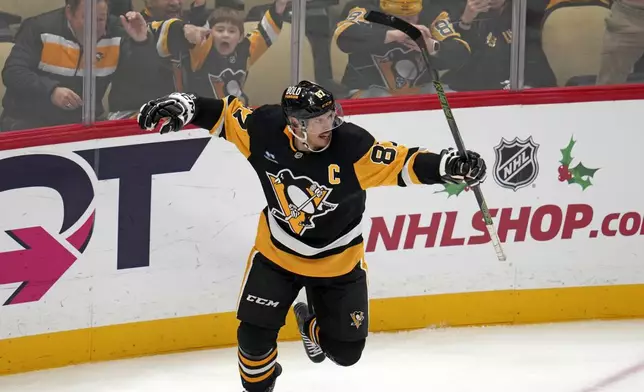 Pittsburgh Penguins' Sidney Crosby (87) celebrates after getting his 600th career goal in the NHL during the second period of an NHL hockey game against the Utah Hockey Club, Saturday, Nov. 23, 2024, in Pittsburgh. (AP Photo/Gene J. Puskar)