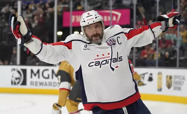 Washington Capitals left wing Alex Ovechkin (8) celebrates after scoring against the Vegas Golden Knights for a hat trick during the third period of an NHL hockey game Sunday, Nov. 17, 2024, in Las Vegas. (AP Photo/John Locher)