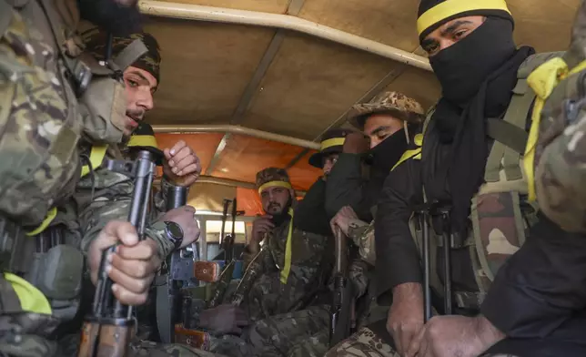 Syrian opposition fighters ride in a truck as they enter the village of Anjara, western outskirts of Aleppo, Syria, Thursday Nov. 28, 2024, part of their major offensive on government-controlled areas in the country's northwestern Syria. (AP Photo/Omar Albam)