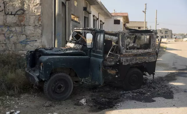 A damaged vehicle belonging to the Syrian Government troops, seen in Kafr Halab, Aleppo countryside, Syria, Friday, Nov. 29, 2024. (AP Photo/Ghaith Alsayed)