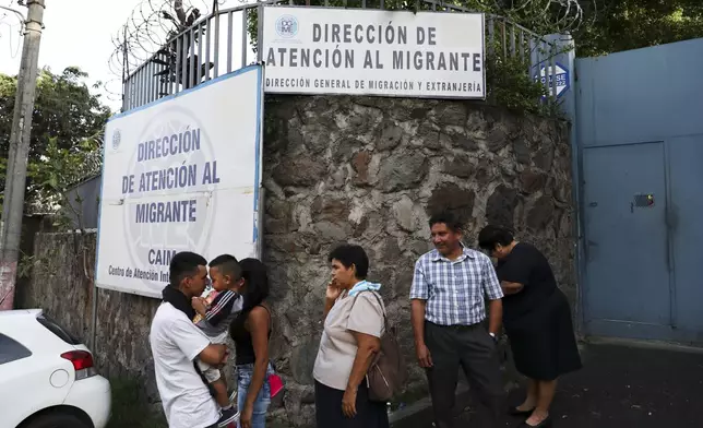 FILE - People gather outside the Migrant Assistance Office on Oct. 9, 2019 in San Salvador, El Salvador. (AP Photo/Eduardo Verdugo, File)