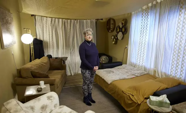 MJ Wilt, a licensed psilocybin facilitator and the owner of a licensed psilocybin service center, poses in a room setup for a patient journey at her facility in Gresham, Ore., Monday, Nov. 18, 2024. (AP Photo/Craig Mitchelldyer)