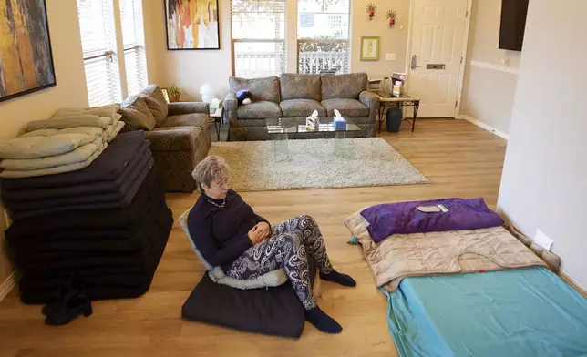 MJ Wilt, a licensed psilocybin facilitator and the owner of a licensed psilocybin service center, sits in a room setup for groups at her facility in Gresham, Ore., Monday, Nov. 18, 2024. (AP Photo/Craig Mitchelldyer)