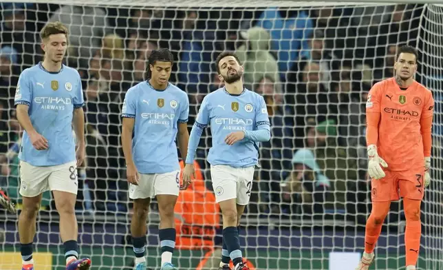 Manchester City's Bernardo Silva, second right, reacts after Feyenoord scored their third goal during the Champions League opening phase soccer match between Manchester City and Feyenoord at the Etihad Stadium in Manchester, England, Tuesday, Nov. 26, 2024. (AP Photo/Dave Thompson)