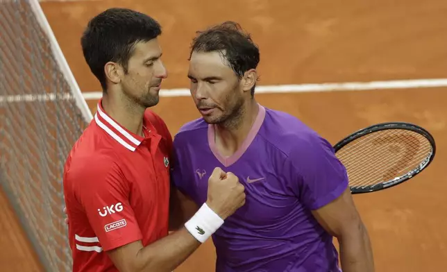 Spain's Rafael Nadal, right, greets Serbia's Novak Djokovic after deleting him at their final match of the Italian Open tennis tournament, in Rome, Sunday, May 16, 2021. Nadal won 7-5, 1-6, 6-3. (AP Photo/Gregorio Borgia)