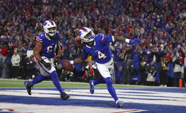 Buffalo Bills running back James Cook (4) celebrates after scoring on a 6-yard run as teammate O'Cyrus Torrence (64) watches during the first half of an NFL football game against the Kansas City Chiefs Sunday, Nov. 17, 2024, in Orchard Park, N.Y. (AP Photo/Jeffrey T. Barnes)