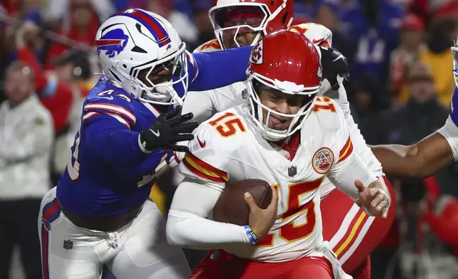 Kansas City Chiefs quarterback Patrick Mahomes (15) is pressured by Buffalo Bills linebacker Von Miller, left, during the first half of an NFL football game Sunday, Nov. 17, 2024, in Orchard Park, N.Y. (AP Photo/Jeffrey T. Barnes)