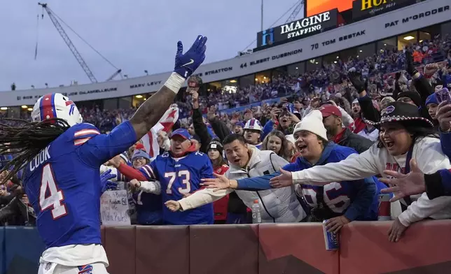 Buffalo Bills running back James Cook (4) celebrates after scoring during the first half of an NFL football game against the Kansas City Chiefs Sunday, Nov. 17, 2024, in Orchard Park, N.Y. (AP Photo/Julia Demaree Nikhinson)