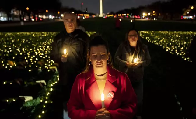 Rachel Lamar of Ft. Lauderdale, Fla., a member of Mothers Against Drunk Driving (MADD), attends a candlelight vigil for people killed by drunk drivers, Tuesday, Nov. 19, 2024, on the National Mall, in Washington. (AP Photo/Jacquelyn Martin)