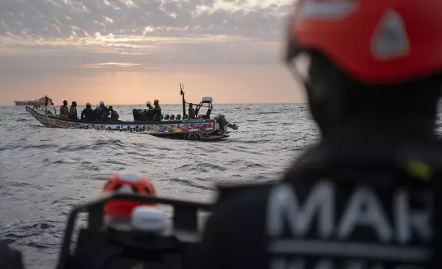 Senegalese sailors in their zodiac approach a fishermen's pirogue to check during a mission to search for migrant boats near the coast of Dakar, Senegal, Saturday, Nov. 16, 2024. (AP Photo/Sylvain Cherkaoui)