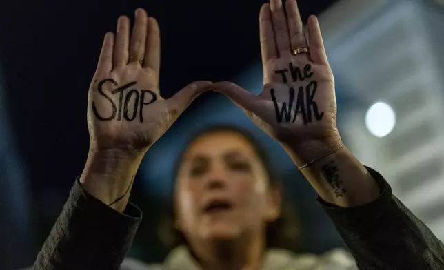 A woman shouts slogans during a protest against Prime Minister Benjamin Netanyahu's government and call for the release of hostages held in the Gaza Strip by the Hamas militant group, in Tel Aviv, Israel, Saturday, Nov. 16, 2024. (AP Photo/Francisco Seco)