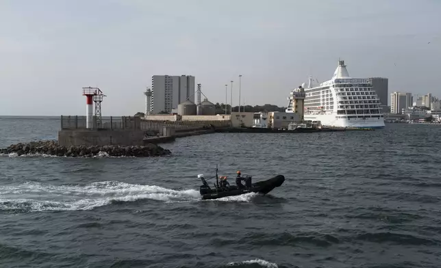 Senegalese sailors in their zodiac return to port following a mission to search for illegal migrant boats near the coast of Dakar, Senegal, Saturday, Nov.16, 2024. (AP Photo/Sylvain Cherkaoui)