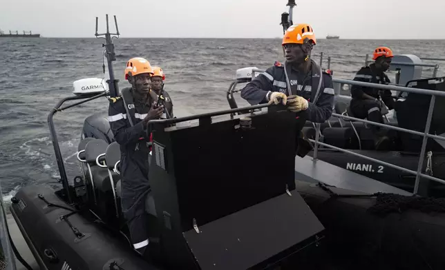 Senegalese sailors prepare their zodiacs during a mission to search for illegal migrant boats near the coast of Dakar, Senegal, Saturday, Nov.16, 2024. (AP Photo/Sylvain Cherkaoui)