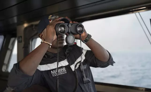 A Senegalese sailor surveys the sea on the patrol vessel Niani during a mission to search for illegal migrant boats near the coast of Dakar, Senegal, Saturday, Nov.16, 2024. (AP Photo/Sylvain Cherkaoui)