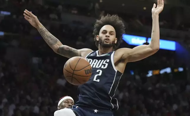 Dallas Mavericks center Dereck Lively II (2) gets an easy dunk against the Miami Heat during the first half of an NBA basketball game, Sunday, Nov. 24, 2024, in Miami. (AP Photo/Jim Rassol)