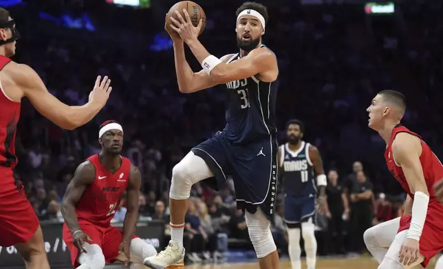 Dallas Mavericks guard Klay Thompson (31) looks to pass the ball against the Miami Heat during the first half of an NBA basketball game, Sunday, Nov. 24, 2024, in Miami. (AP Photo/Jim Rassol)