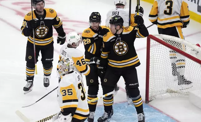 Boston Bruins' Charlie Coyle (13) celebrates after his goal against Pittsburgh Penguins' Tristan Jarry (35) during the first period of an NHL hockey game, Friday, Nov. 29, 2024, in Boston. (AP Photo/Michael Dwyer)