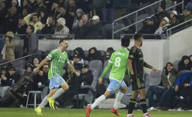 Seattle Sounders forward Jordan Morris, left reacts after scoring a goal during overtime in an MLS Western Conference semifinal soccer match in Los Angeles, Saturday, Nov. 23, 2024. (AP Photo/Kyusung Gong)