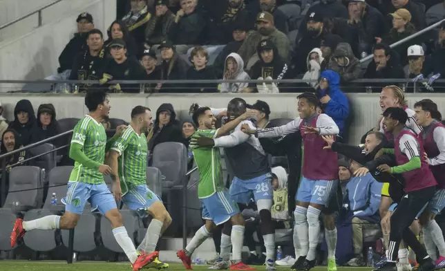 Seattle Sounders players celebrate a goal by forward Jordan Morris (13) during overtime in an MLS Western Conference semifinal soccer match against the Los Angeles FC in Los Angeles, Saturday, Nov. 23, 2024. (AP Photo/Kyusung Gong)