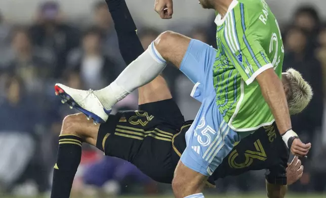 Los Angeles FC defender Aaron Long (33) attempts a bicycle kick over Seattle Sounders defender Jackson Ragen (25) during the second half of an MLS Western Conference semifinal soccer match in Los Angeles, Saturday, Nov. 23, 2024. (AP Photo/Kyusung Gong)