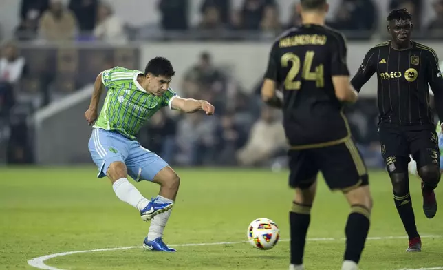 Seattle Sounders midfielder Obed Vargas, left, shoots during the first half of an MLS Western Conference semifinal soccer match against the Los Angeles FC in Los Angeles, Saturday, Nov. 23, 2024. (AP Photo/Kyusung Gong)