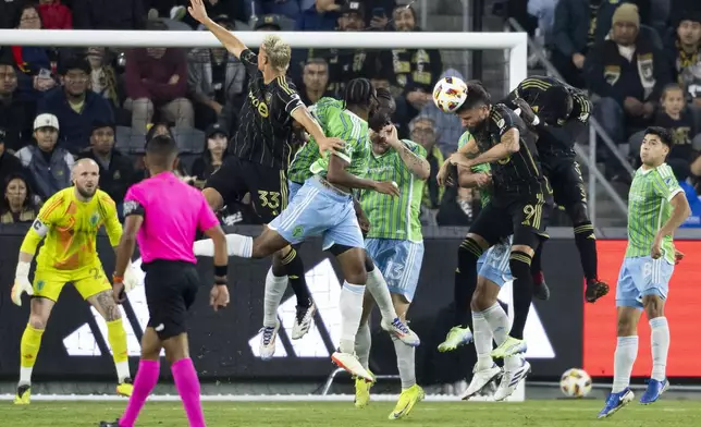 Los Angeles FC forward Olivier Giroud (9) heads the ball during the first half of an MLS Western Conference semifinal soccer match against the Seattle Sounders in Los Angeles, Saturday, Nov. 23, 2024. (AP Photo/Kyusung Gong)