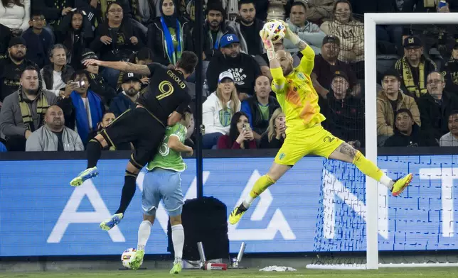 Seattle Sounders goalkeeper Stefan Frei, right, catches the pass intended to Los Angeles FC forward Olivier Giroud during the first half of an MLS Western Conference semifinal soccer match in Los Angeles, Saturday, Nov. 23, 2024. (AP Photo/Kyusung Gong)