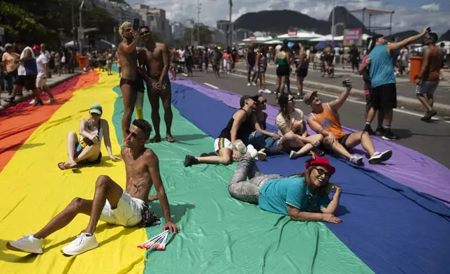 People celebrate the 29th LGBTI+ Rio Pride Parade along Copacabana beach in Rio de Janeiro, Sunday, Nov. 24, 2024. (AP Photo/Bruna Prado)