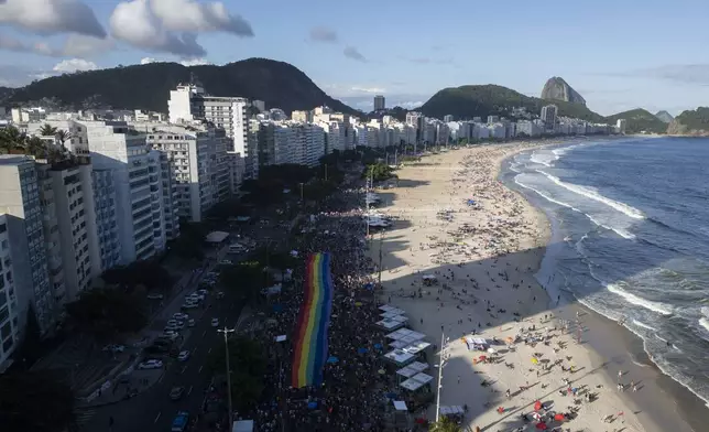 People celebrate the 29th LGBTI+ Rio Pride Parade along Copacabana beach in Rio de Janeiro, Sunday, Nov. 24, 2024. (AP Photo/Bruna Prado)