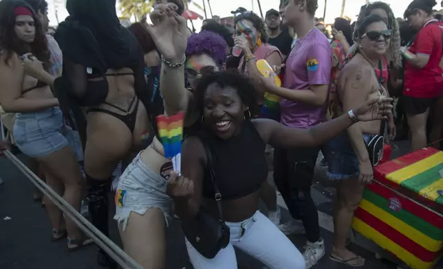 People dance during the 29th LGBTI+ Rio Pride Parade along Copacabana beach in Rio de Janeiro, Sunday, Nov. 24, 2024. (AP Photo/Bruna Prado)