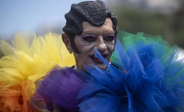 A man performs during the 29th LGBTI+ Rio Pride Parade along Copacabana beach in Rio de Janeiro, Sunday, Nov. 24, 2024. (AP Photo/Bruna Prado)