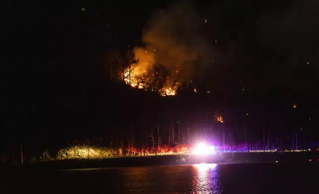 Wildfires burn along the New York and New Jersey border in Greenwood Lake, New York, Wednesday, Nov. 13, 2024. (AP Photo/Eduardo Munoz Alvarez)