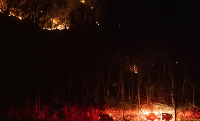 Firefighters attend the wildfires as they burn along the New York and New Jersey border in Greenwood Lake, New York, Wednesday, Nov. 13, 2024. (AP Photo/Eduardo Munoz Alvarez)