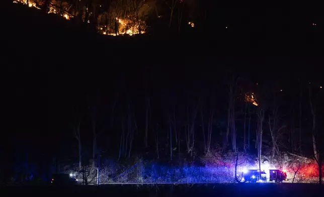 Firefighters attend the wildfires as they burn along the New York and New Jersey border in Greenwood Lake, New York, Wednesday, Nov. 13, 2024. (AP Photo/Eduardo Munoz Alvarez)