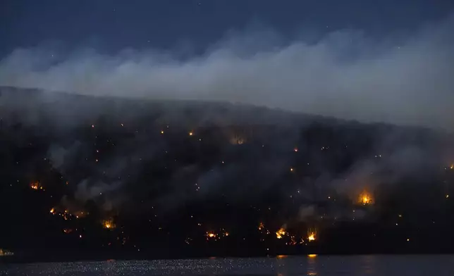 Wildfires burn along the New York and New Jersey border in Greenwood Lake, New York, Wednesday, Nov. 13, 2024. (AP Photo/Eduardo Munoz Alvarez)