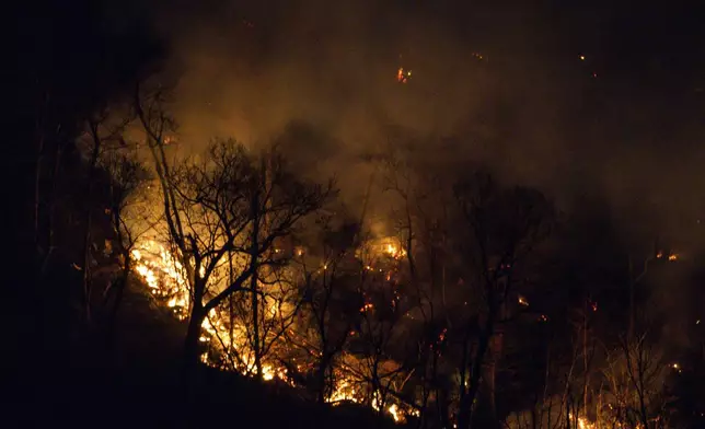 Wildfires burn along the New York and New Jersey border in Greenwood Lake, New York, Wednesday, Nov. 13, 2024. (AP Photo/Eduardo Munoz Alvarez)