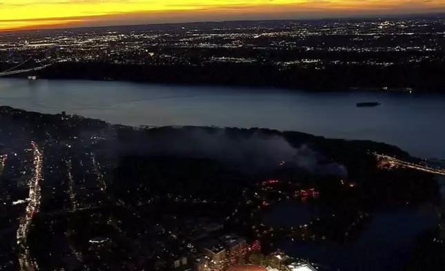 This aerial image taken from video shows a brush fire that broke out in a park on the northern tip of Manhattan in Inwood, N.Y., Wednesday, Nov. 13, 2024. (WABC-TV via AP)