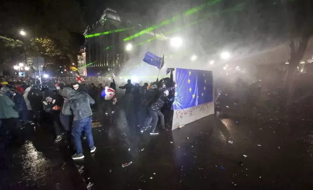 Police use a water cannon to prevent protesters pouring into the streets following Georgian Prime Minister Irakli Kobakhidze's announcement, rallying outside the parliament building in Tbilisi, Georgia, on Friday, Nov. 29, 2024. (AP Photo/Zurab Tsertsvadze)