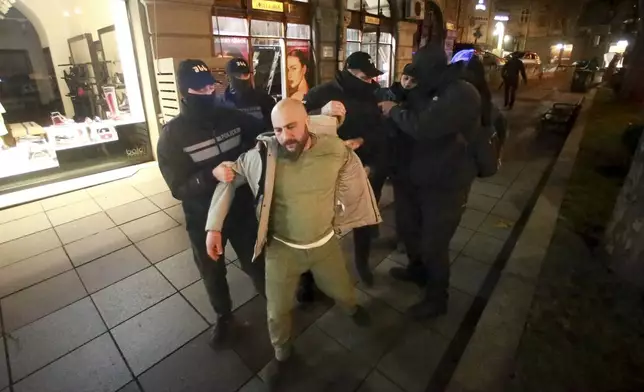 Police detain a protester outside the parliament building in Tbilisi, Georgia, on Friday, Nov. 29, 2024. (AP Photo/Zurab Tsertsvadze)