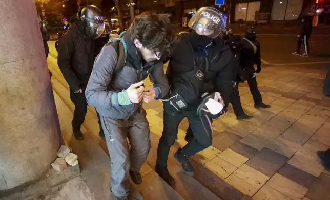 Police detain a protester outside the parliament building in Tbilisi, Georgia, on Friday, Nov. 29, 2024. (AP Photo/Zurab Tsertsvadze)