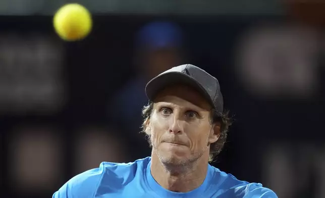 Uruguay's Diego Forlan looks at the ball during a men's doubles tennis match at the 2024 Uruguay Open in Montevideo, Uruguay, Wednesday, Nov. 13, 2024. (AP Photo/Matilde Campodonico)