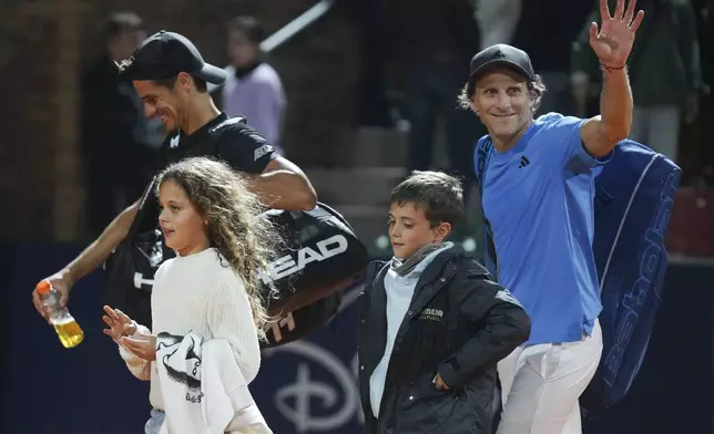 Uruguay's Diego Forlan, right, and teammate Federico Coria leave the court after a men's doubles match against Boris Arias and Federico Zeballos at the 2024 Uruguay Open in Montevideo, Uruguay, Wednesday, Nov. 13, 2024. (AP Photo/Matilde Campodonico)