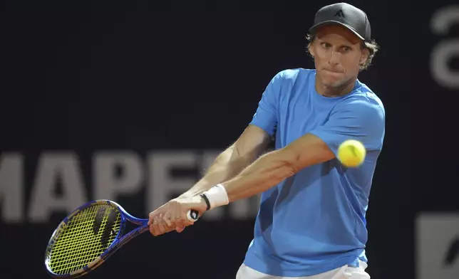 Uruguay's Diego Forlan returns the ball to Boris Arias and Federico Zeballos during a men's doubles tennis match at the 2024 Uruguay Open in Montevideo, Uruguay, Wednesday, Nov. 13, 2024. (AP Photo/Matilde Campodonico)