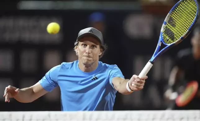 Uruguay's Diego Forlan returns the ball to Boris Arias and Federico Zeballos during a men's doubles tennis match with teammate Federico Coria at the 2024 Uruguay Open in Montevideo, Uruguay, Wednesday, Nov. 13, 2024. (AP Photo/Matilde Campodonico)