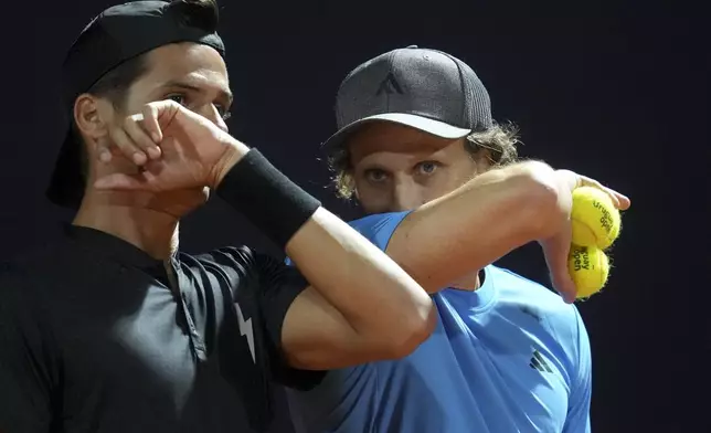 Uruguay's Diego Forlan, right, talks to teammate Federico Coria during a men's doubles tennis match against Boris Arias and Federico Zeballos at the 2024 Uruguay Open in Montevideo, Uruguay, Wednesday, Nov. 13, 2024. (AP Photo/Matilde Campodonico)